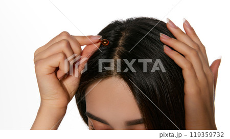 Woman applying vitamin ampoule for hair treatment, taking care after hair condition, nourishing and strengthening Woman applying vitamin ampoule for hair treatment, taking care after hair condition, nourishing and strengthening 119359732