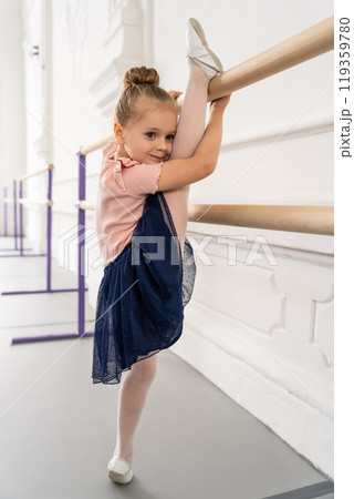 Kid practicing ballet in pointe shoes showing elegance and grace during dance class in studio Kid practicing ballet in pointe shoes showing elegance and grace during dance class in studio 119359780