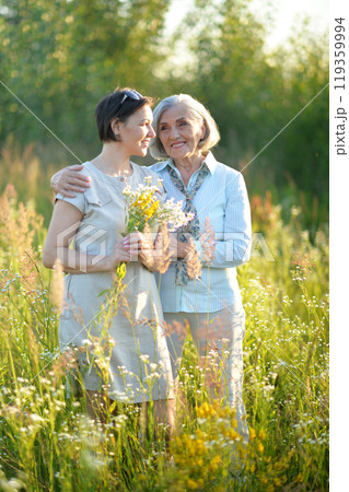 An elderly woman with her daughter in the park in summer 119359994