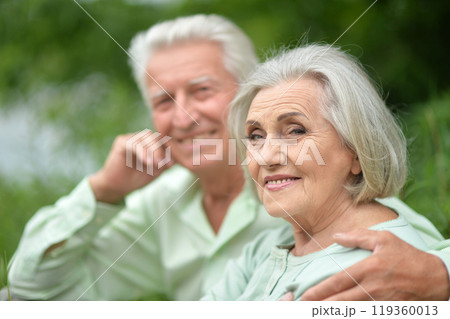 Portrait of beautiful senior couple posing in the park Portrait of beautiful senior couple posing in the park 119360013