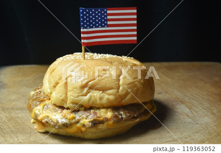 fried mashed beef cheese hamburger stuffed mayonnaise sauce with ketchup stick USA flag on wooden chopping block fried mashed beef cheese hamburger stuffed mayonnaise sauce with ketchup stick USA flag on wooden chopping block 119363052