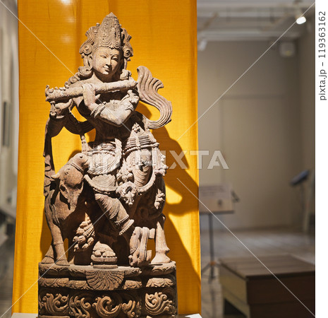 Close-up view on Statue Of Krishna Playing Flute. Krishnas Love Songs Are Both Shravya And Drishya -heard And Seen-. He Is God Of Protection, Compassion, Tenderness, And Love. Krishna Is Major Deity 119363162