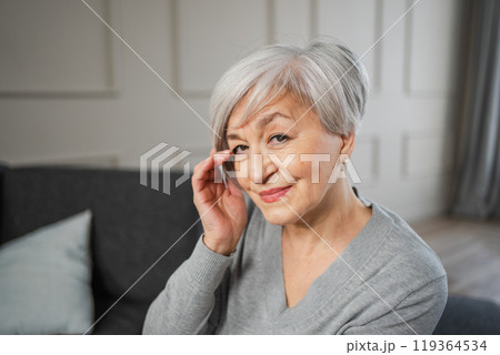 Portrait of confident stylish european middle aged senior woman. Older mature 60s lady smiling at home. Happy attractive senior female looking camera close up face headshot portrait. Happy people 119364534