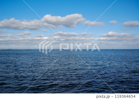Odessa Bay of the Black Sea. Otrada Beach, on the Black Sea coast.The coastline is visible in the distance - the settlement of Kotovsky is located there. Odessa Bay of the Black Sea. Otrada Beach, on the Black Sea coast.The coastline is visible in the distance - the settlement of Kotovsky is located there. 119364654