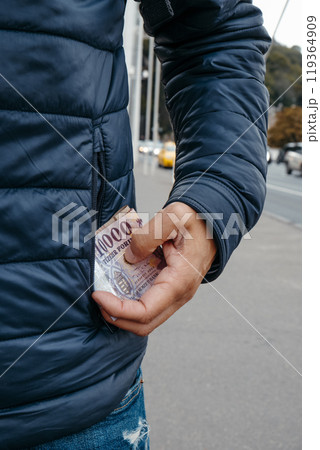 man takes out or puts some forint notes into his pocket man takes out or puts some forint notes into his pocket 119364909