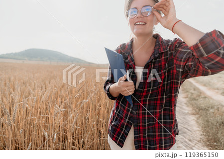 Smiling Woman in a Wheat Field with Clipboard Smiling Woman in a Wheat Field with Clipboard 119365150