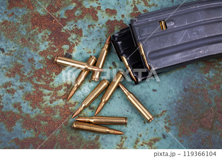 Ammunition with magazine on rusty metal 119366104