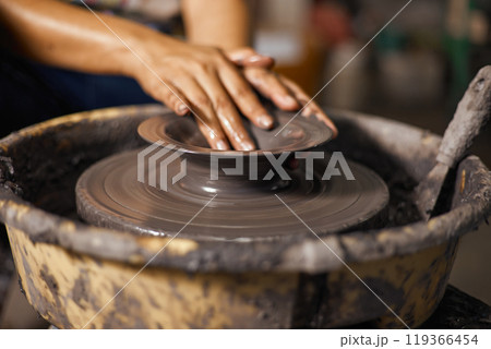 Hands of craftsman artist working on pottery wheel Hands of craftsman artist working on pottery wheel 119366454