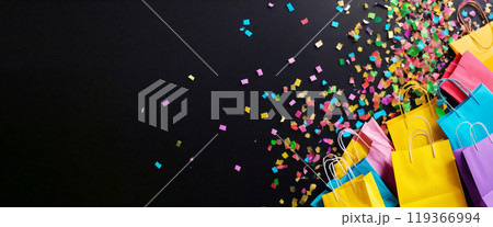 Colorful shopping bags celebrating on black background with confetti 119366994