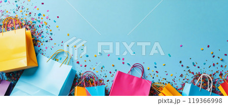 Colorful shopping bags scattered with confetti on blue background Colorful shopping bags scattered with confetti on blue background 119366998