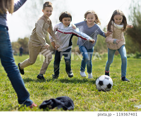 Children play with ball outdoors in spring Children play with ball outdoors in spring 119367401
