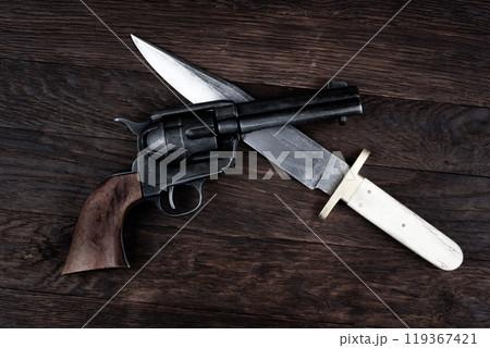 Old West Revolver with bowie knife on leather jacket 119367421