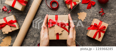 Woman hands holding gift box, preparing surprise for holiday, top view, Christmas and New Year concept 119368285