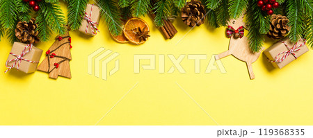 Top view of Christmas decorations on yellow background. New Year holiday concept with copy space 119368335