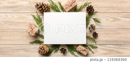 Flat lay Christmas composition. square Paper blank, pine tree branches, christmas decorations on Colored background. Top view, copy space for text Flat lay Christmas composition. square Paper blank, pine tree branches, christmas decorations on Colored background. Top view, copy space for text 119368360
