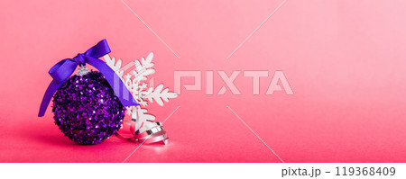 Christmas ball on colored background. decoration bauble with ribbon bow with copy space 119368409