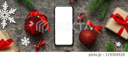 Digital phone mock up with rustic Christmas decorations for app presentation top view with empty space for you design. Christmas online shopping concept. Tablet with copy space on colored background 119368426