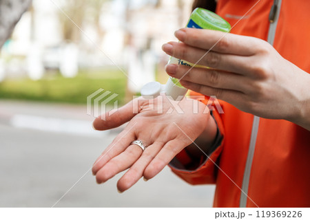 A woman applies an antibacterial antiseptic hand gel to disinfect and clean her hands. Close up of hands. Concept of influenza virus, coronavirus epidemic and infectious diseases A woman applies an antibacterial antiseptic hand gel to disinfect and clean her hands. Close up of hands. Concept of influenza virus, coronavirus epidemic and infectious diseases 119369226