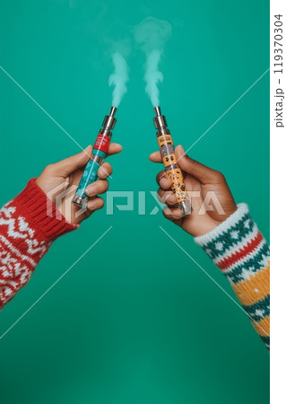 Two colorful vapes in hands wearing festive sweaters, with a green background and vapor rising 119370304