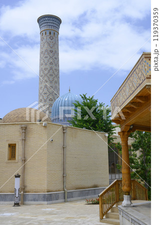 Minaret and mosque with wooden carvings and traditional Uzbek mosaics in Samarkand, Uzbekistan Minaret and mosque with wooden carvings and traditional Uzbek mosaics in Samarkand, Uzbekistan 119370359