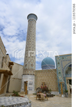 Minaret, mosque and courtyard, buiildings with traditional Uzbek mosaics in Samarkand, Uzbekistan Minaret, mosque and courtyard, buiildings with traditional Uzbek mosaics in Samarkand, Uzbekistan 119370366