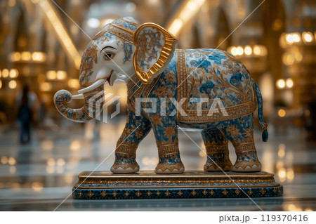 An ornate golden and blue elephant statue, richly detailed and set in a luxurious indoor space An ornate golden and blue elephant statue, richly detailed and set in a luxurious indoor space 119370416