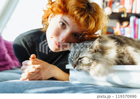 portrait red-haired attractive young woman with fluffy big cat portrait red-haired attractive young woman with fluffy big cat 119370990