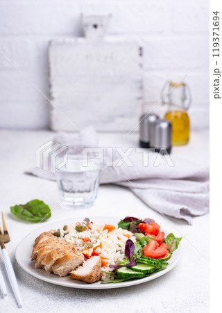 Grilled chicken breast with rice 119371694