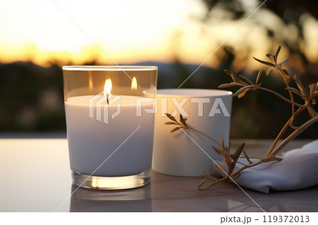 Minimalist candle scene at sunset with olive branch decor, perfect for relaxation, spa concepts, or evening rituals 119372013