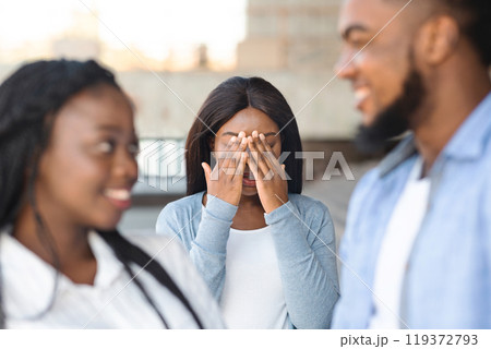 Unrequited Love Concept. Desperate african american girl jealous to her dating friends, covering her face with hands, envy about their relations 119372793