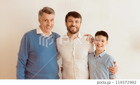 Happy Man Hugging Little Son And Senior Father Standing Over White Background. Multi-Generational Male Family. Panorama 119372902