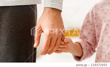 Little daughter holding father finger, close up, supporting, care, parenthood concept 119372935