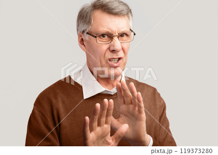 Disgust. Disgusted Senior Man Gesturing No Disapproving Something Posing On Gray Background. Studio Shot 119373280