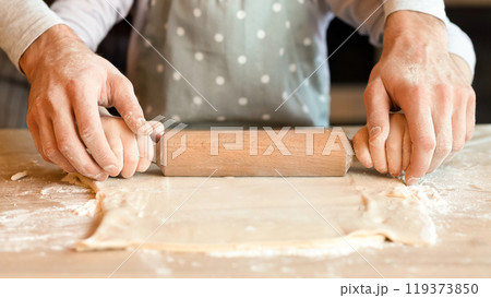Homemade Food Concept. Unrecognizable Man And His Little Daughter Rolling Pastry Dough Together, Cooking Bakery In Kitchen, Cropped Image, Closeup Homemade Food Concept. Unrecognizable Man And His Little Daughter Rolling Pastry Dough Together, Cooking Bakery In Kitchen, Cropped Image, Closeup 119373850