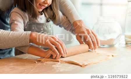 Father Showing His Cute Little Daughter How To Roll Dough For Cookies, Family Baking In Kitchen Together, Cropped Image With Copy Space Father Showing His Cute Little Daughter How To Roll Dough For Cookies, Family Baking In Kitchen Together, Cropped Image With Copy Space 119373922