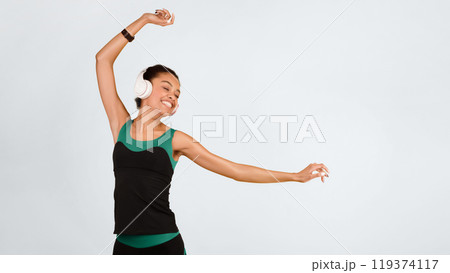 Workout Music. Joyful Afro Girl In Headphones Dancing On Yellow Backgorund Listening To Favorite Song In Studio. Panorama, Copy Space 119374117