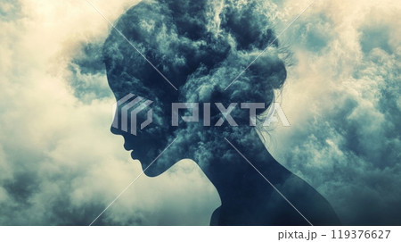 The silhouette of a woman reveals a striking blend of clouds, capturing a dreamy essence as she stands against a dynamic sky, evoking thoughts of introspection and creativity. 119376627