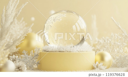 A spherical crystal globe sits atop a delicate white base, surrounded by fluffy white decor and golden ornaments, creating a serene winter ambiance perfect for festive display. 119376628