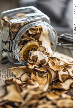 Dried porcini mushrooms. Sliced boletus in jar on wooden table. Dried porcini mushrooms. Sliced boletus in jar on wooden table. 119377173