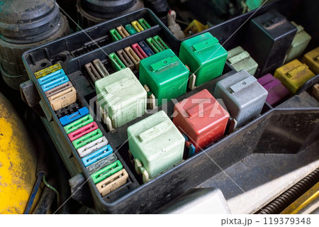 Close-up of old automotive fuse kit for controlling various vehicle systems. Select focus 119379348