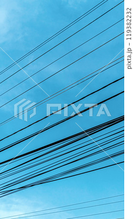 Busy Electricity pole with hanging cables around the city. Aerial small city in south east Asia before busy hours. Busy Electricity pole with hanging cables around the city. Aerial small city in south east Asia before busy hours. 119382232