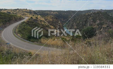 Majestic Canyon with Scenic Road by River Duero Majestic Canyon with Scenic Road by River Duero 119384331