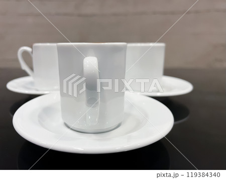 Morning Coffee Ritual. Triple Turkish Coffee Enjoyment. A high-resolution photo taken with the simple and elegant design of traditional Turkish coffee cups. Morning Coffee Ritual. Triple Turkish Coffee Enjoyment. A high-resolution photo taken with the simple and elegant design of traditional Turkish coffee cups. 119384340