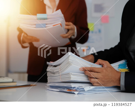 Audit concept,Administrator business man financial inspector and secretary making report calculating balance. Internal Revenue Service checking document. Audit concept,Administrator business man financial inspector and secretary making report calculating balance. Internal Revenue Service checking document. 119384527