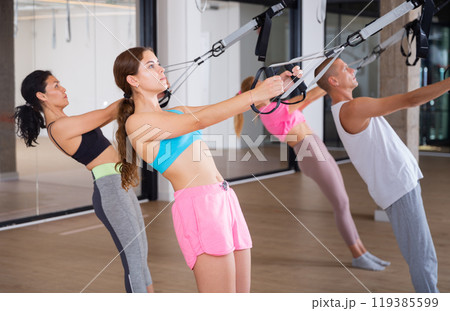 People training trx pilates at group class 119385599