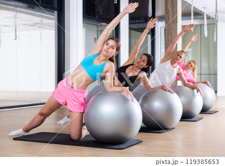 Group of people doing stretching exercises 119385653