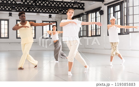 Group of young people learning modern dance movements 119385883
