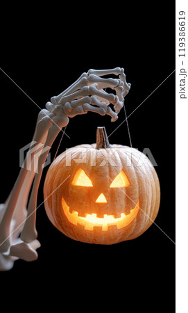 A skeleton is holding a pumpkin with a light inside 119386619