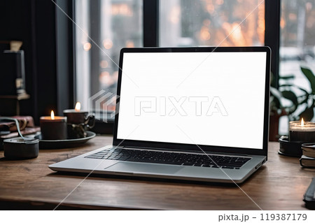 Laptop with a white screen mock up on table in the office of Christmas decor with bokeh lights, candles, overtime work on holidays, home office, Black Friday,. AI generated 119387179