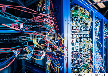 Server rack with fiber optic cables attached to front panel swit Server rack with fiber optic cables attached to front panel swit 119387321